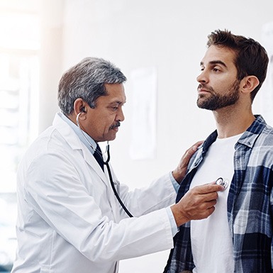 Doctor listening to patient’s heartbeat