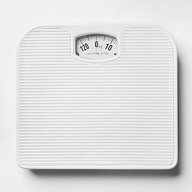 Close-up of bathroom scale on a white floor