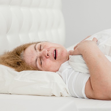 Senior woman snoring in bed