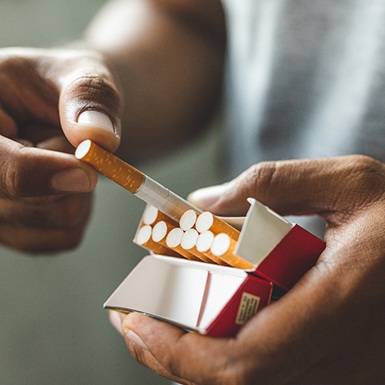 Taking a cigarette out of a full box