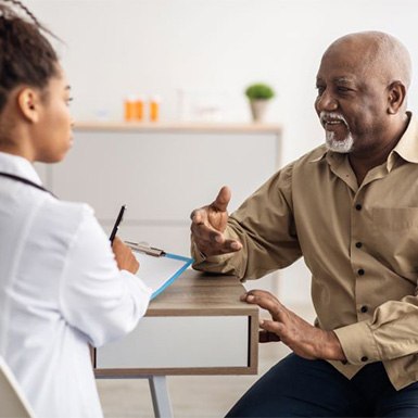 Doctor listening to patient and taking notes