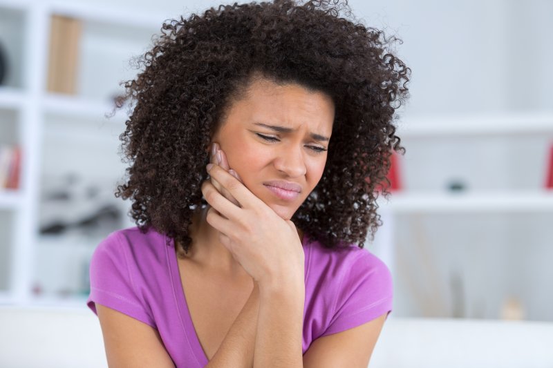 A young woman suffering from a stiff or locked jaw